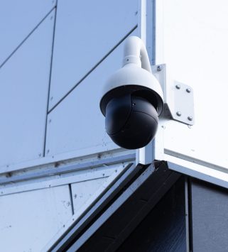 Close-up of high-tech video browsing camera on white building. Photo with depth of field